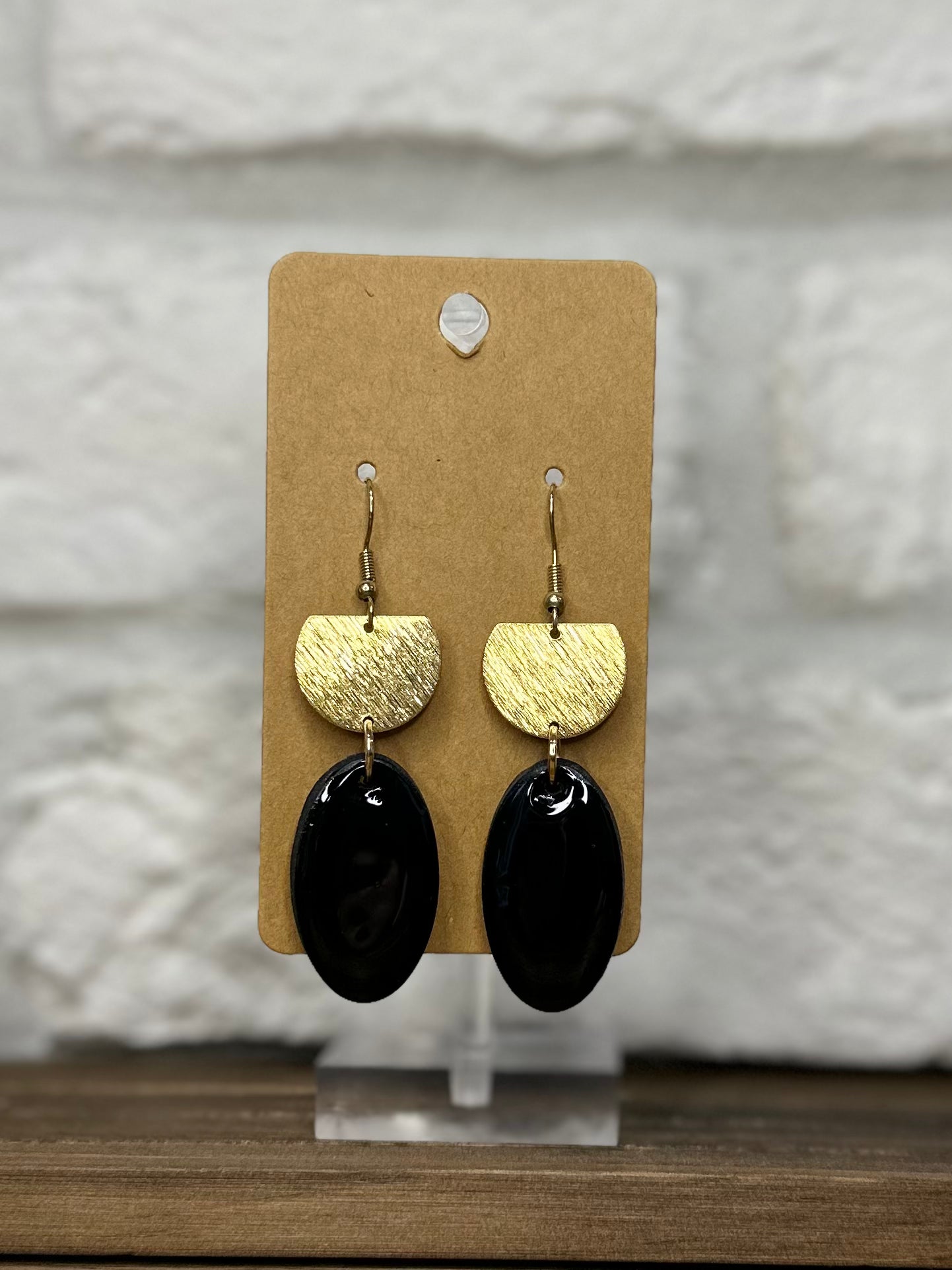 Black oval w/ gold half circle