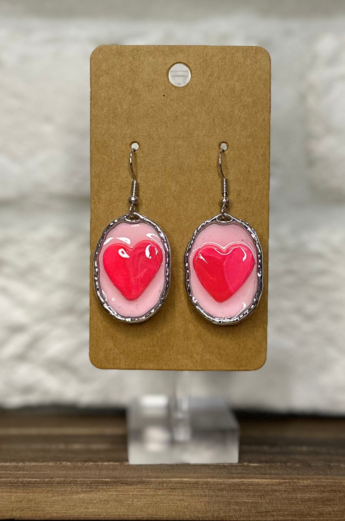 Silver oval heart pink background